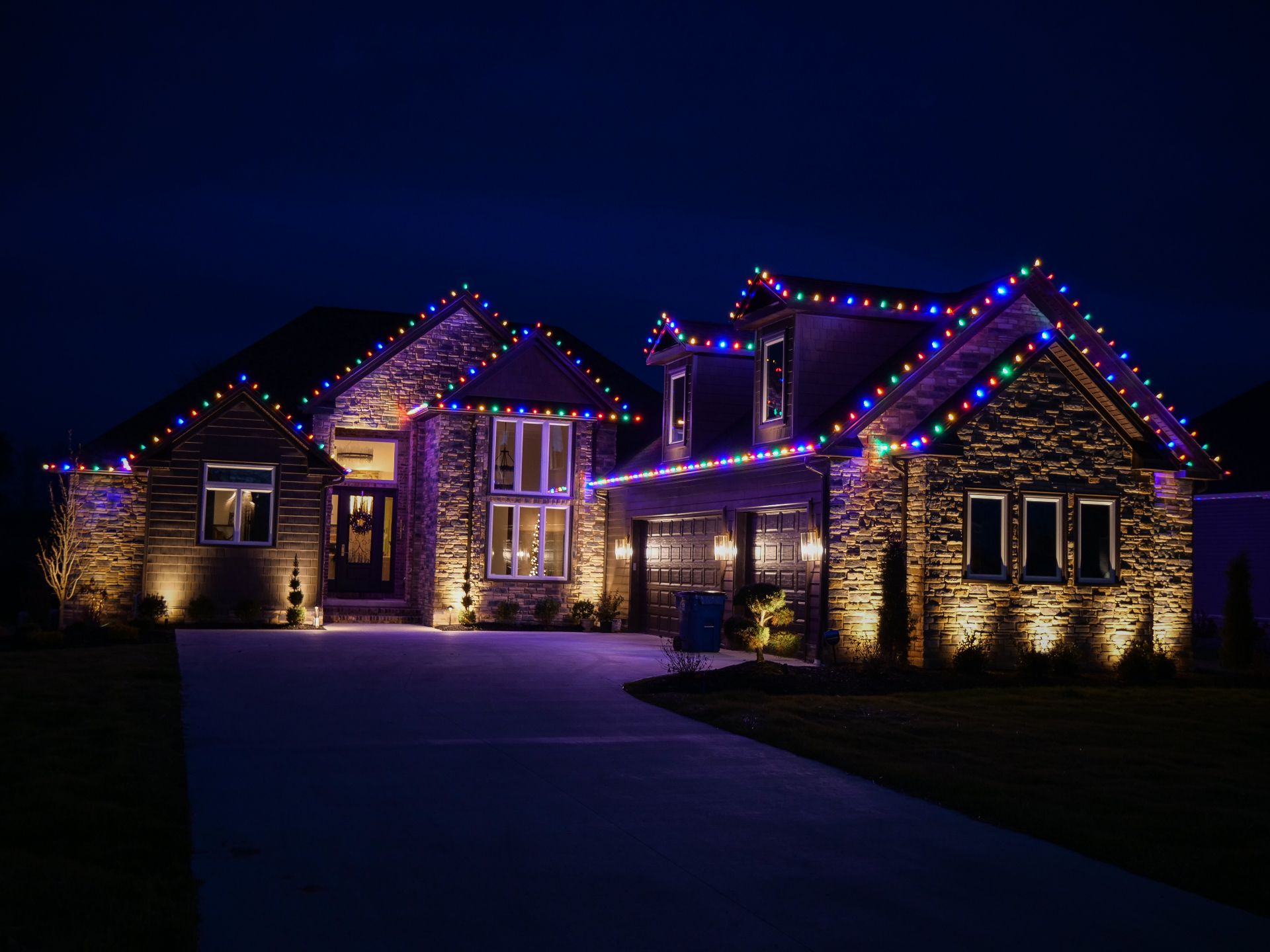 Christmas lighting on a home at night