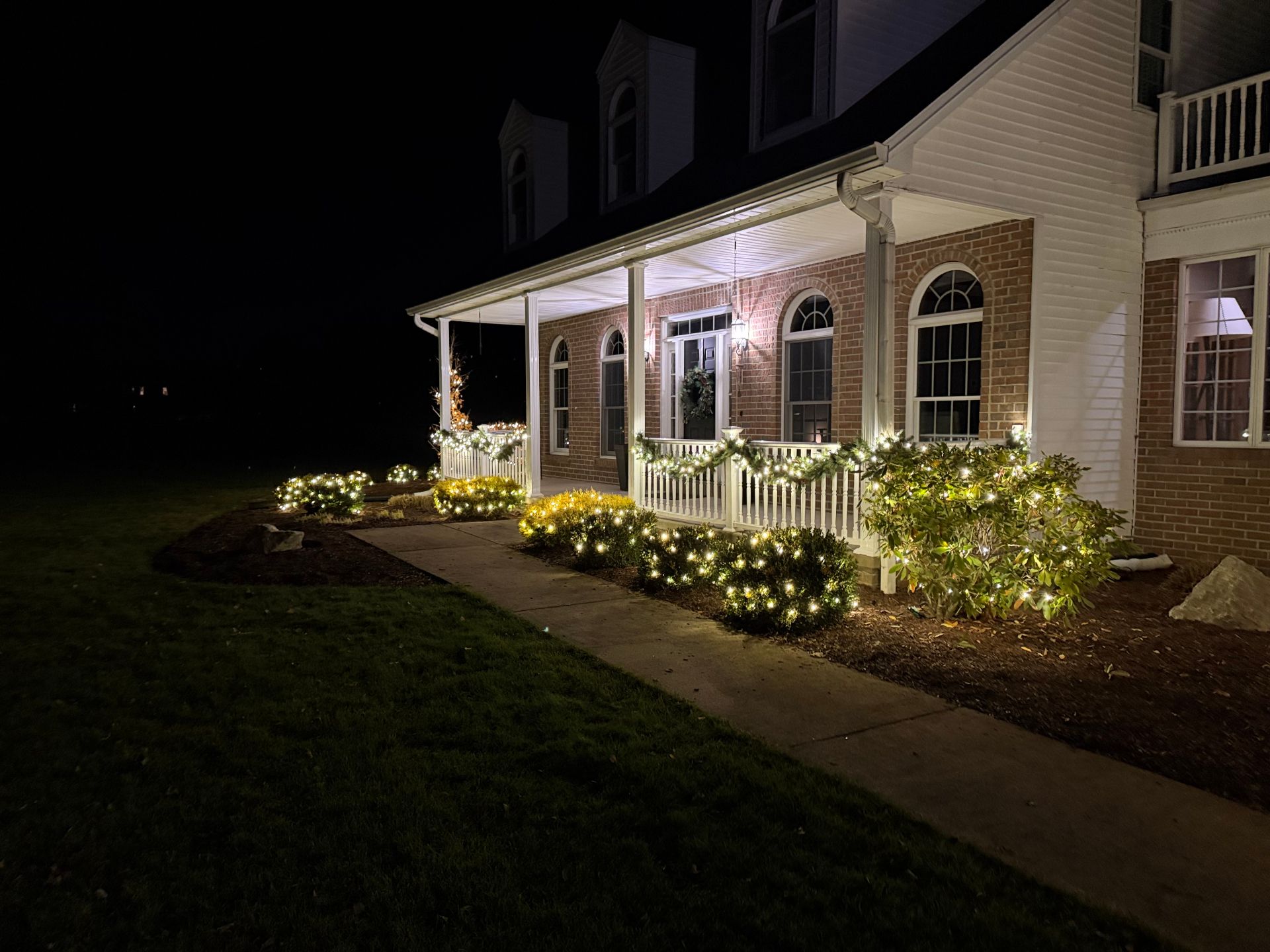 Porch with garland and shrub lights