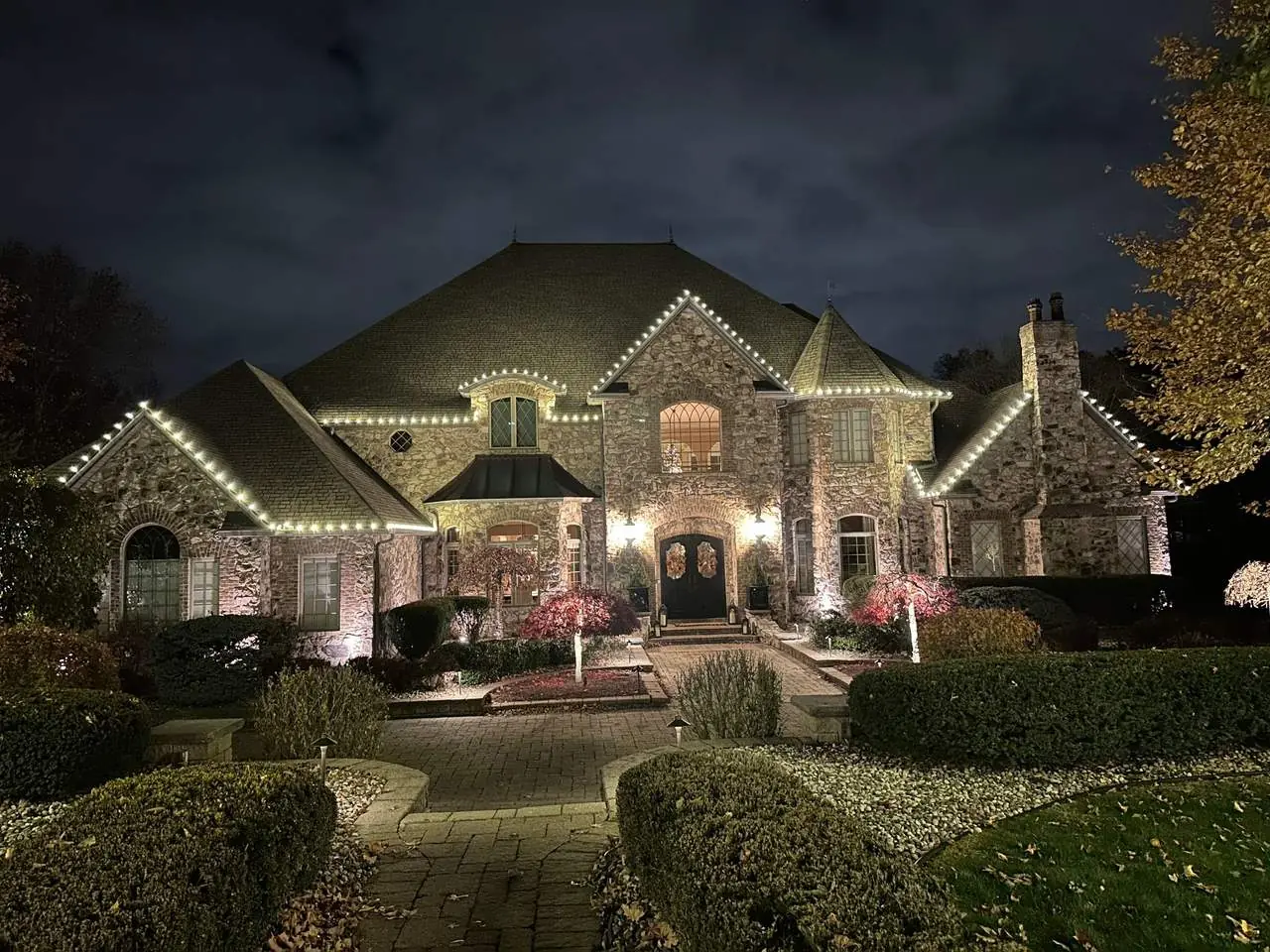 Stone estate with roofline lighting