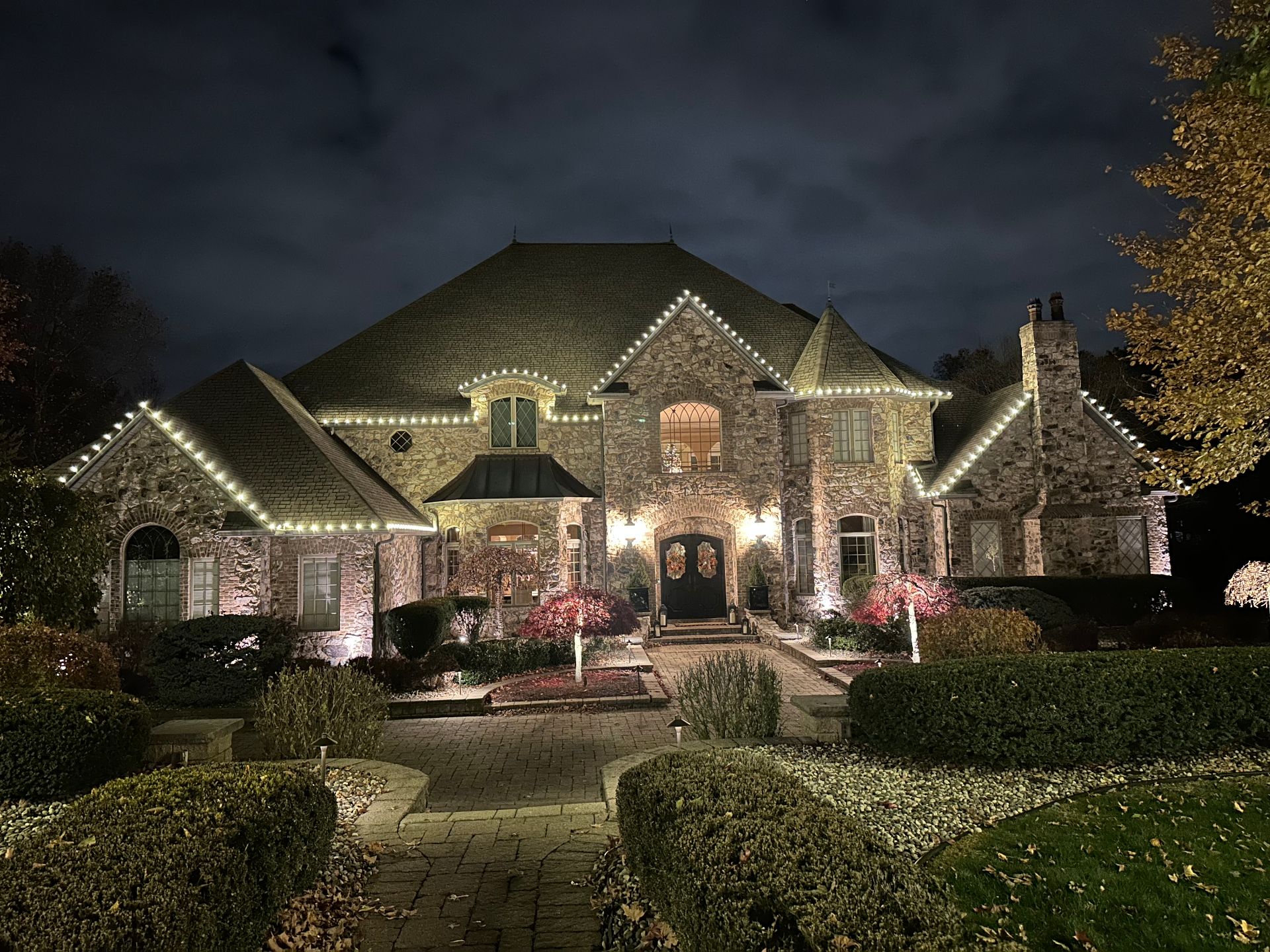 Stone estate with roofline lighting