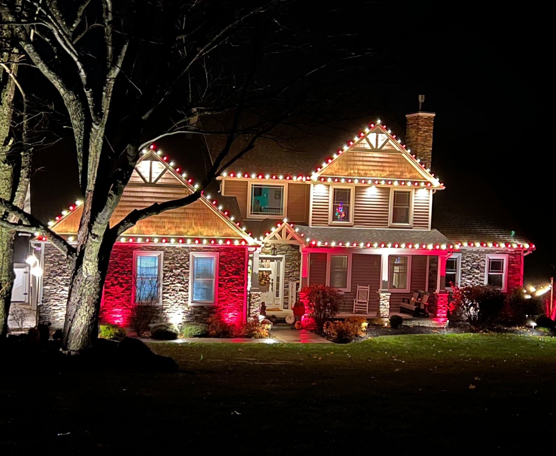 Red and white roofline with landscape lighting