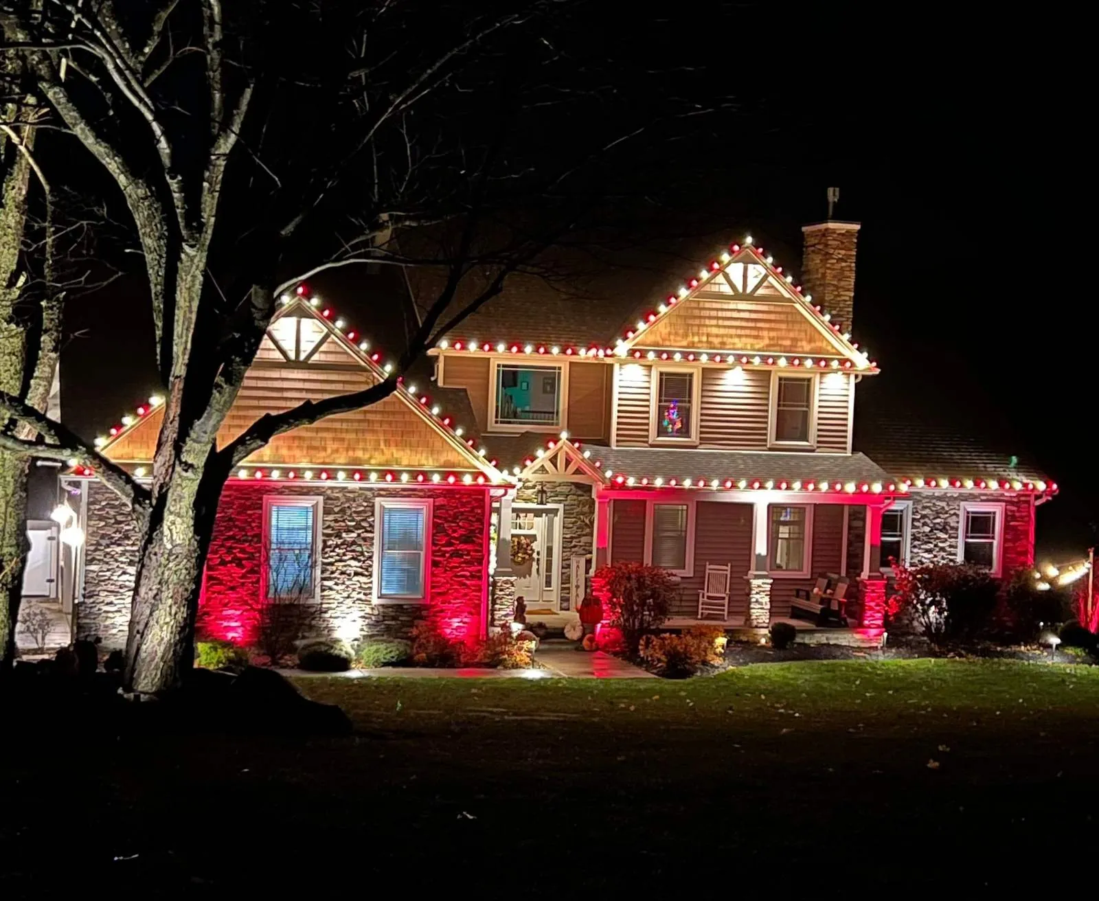 Red and white roofline with landscape lighting