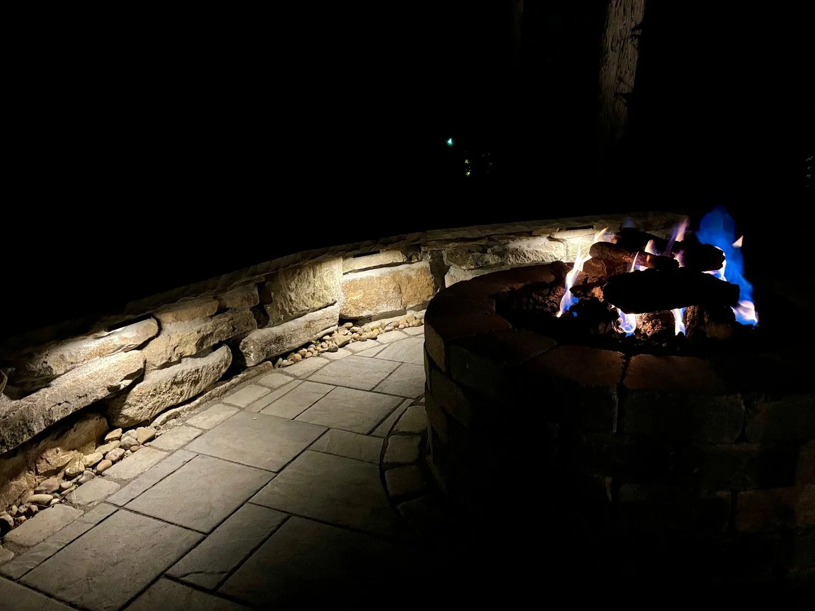 Outdoor fire pit with landscape lighting