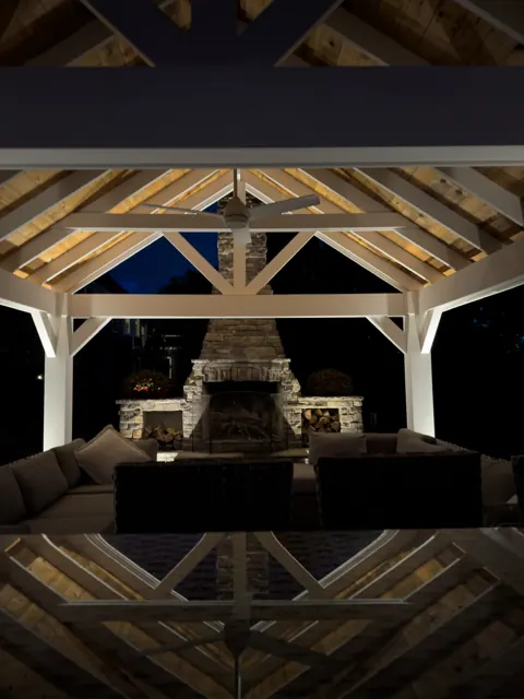 Timber pavilion and stone fireplace lit from within