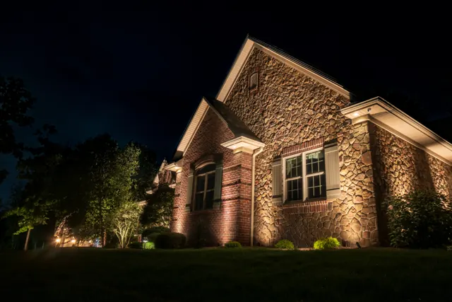 Brick and stone gable washed with warm uplighting