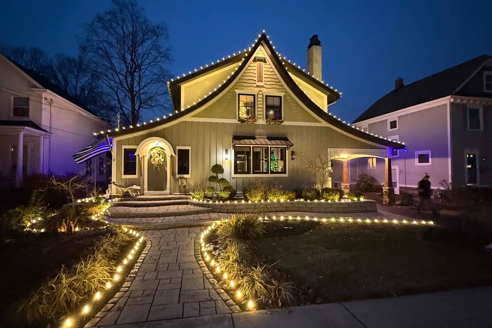 Permanent roofline lighting with lit walkway and landscape beds