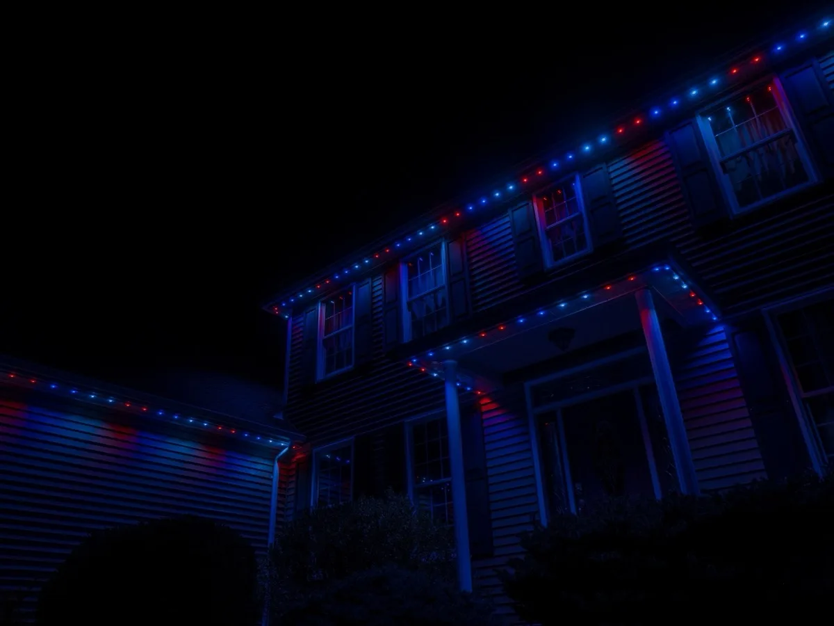 Permanent roofline lights on a two-storey home set to red, white and blue for the Fourth of July
