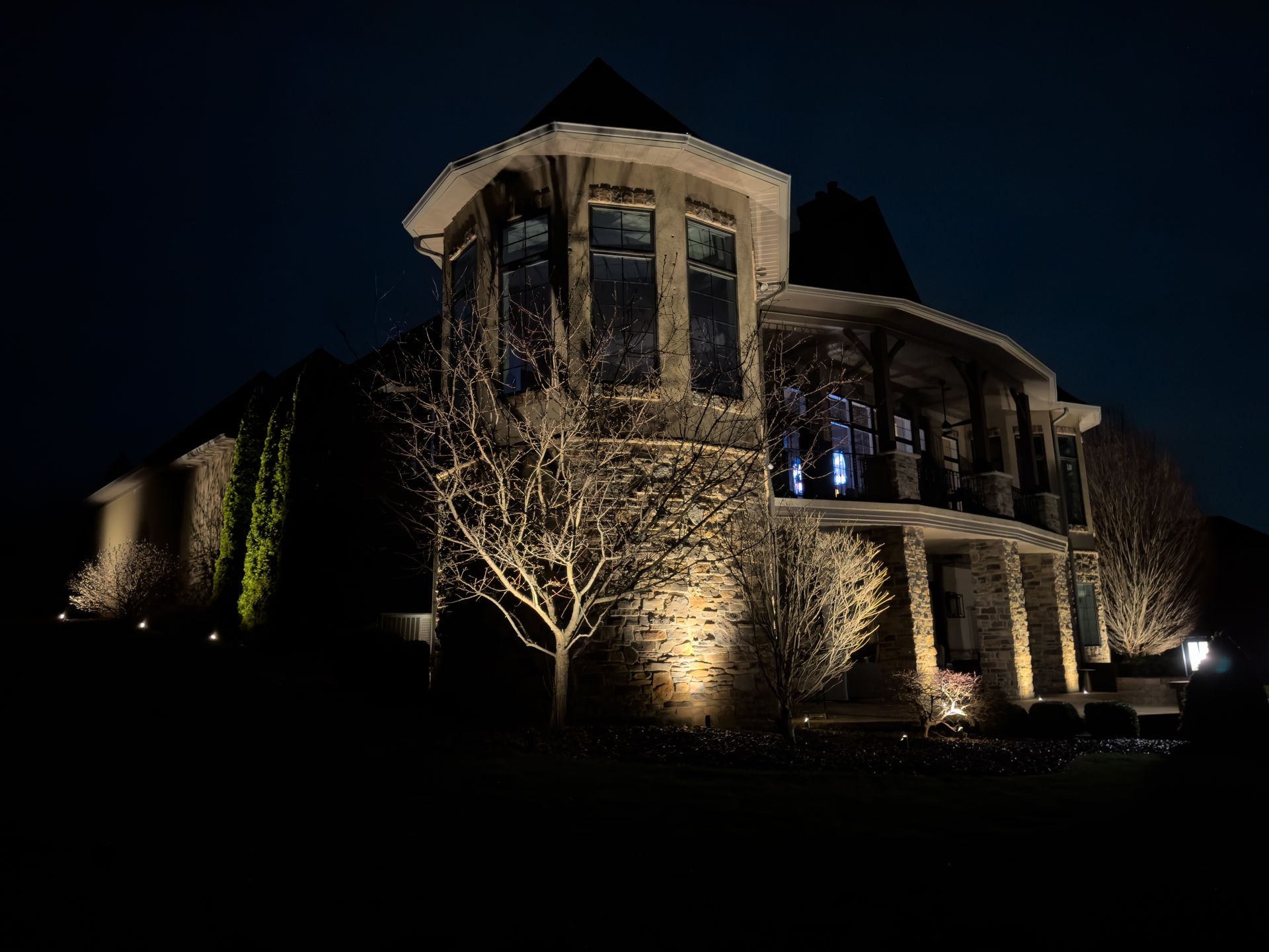 Beautiful home with professional landscape lighting at night
